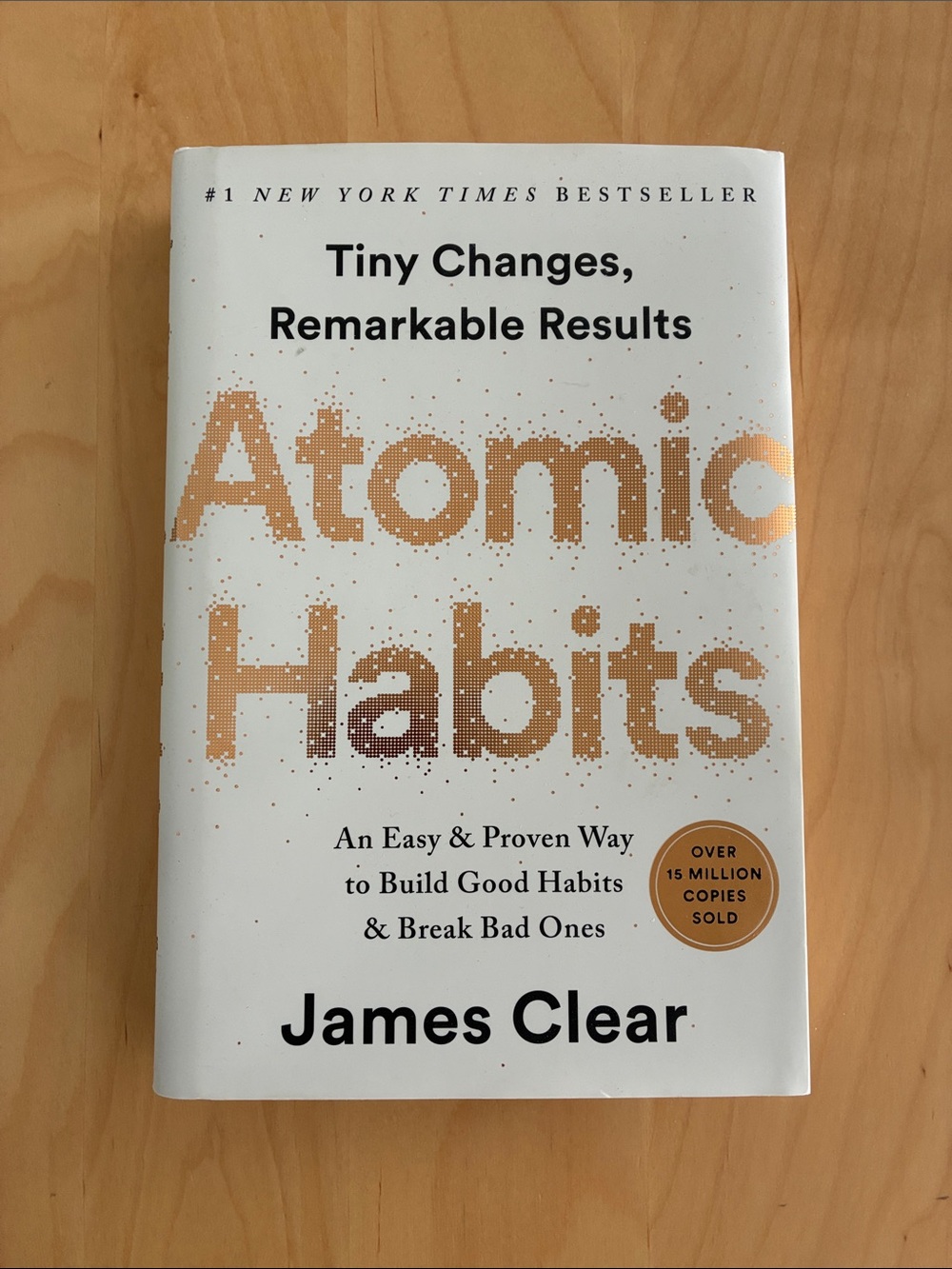 Atomic Habits by James Clear - White & Gold Hardcover book